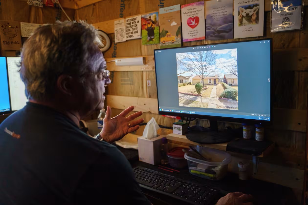 Kern with a photo of his father-in-law’s home that he helped sell.