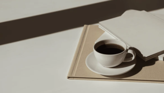 a coffee cup with notebooks