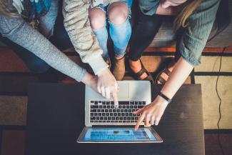 three person pointing the silver laptop computer by John Schnobrich courtesy of Unsplash.