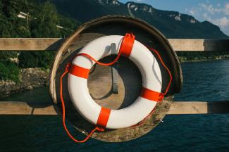 white and red inflatable ring on brown wooden dock during daytime by Elimende Inagella courtesy of Unsplash.