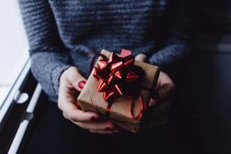 person holding present box by freestocks courtesy of Unsplash.