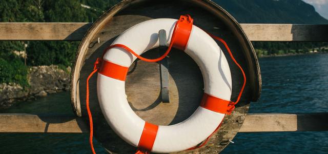 white and red inflatable ring on brown wooden dock during daytime by Elimende Inagella courtesy of Unsplash.