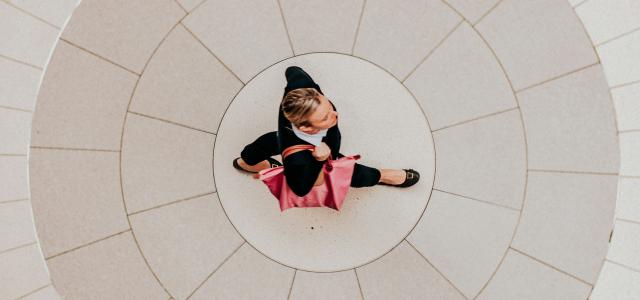 a small child is sitting on the floor by Marcos Paulo Prado courtesy of Unsplash.
