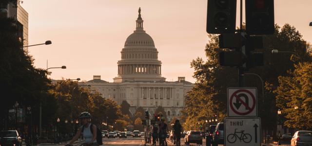 people biking on road and different vehicles viewing United States Capitol during daytime screenshot by Andy Feliciotti courtesy of Unsplash.